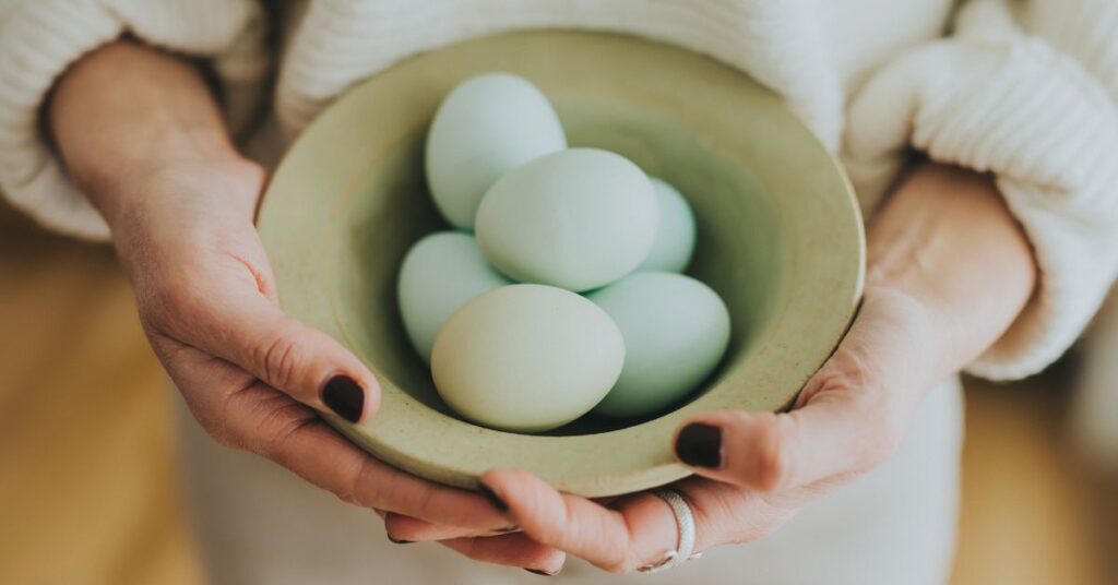 Woman holding a bowl of eggs
