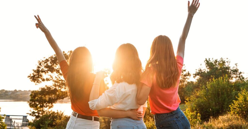 A group of women facing the sunset