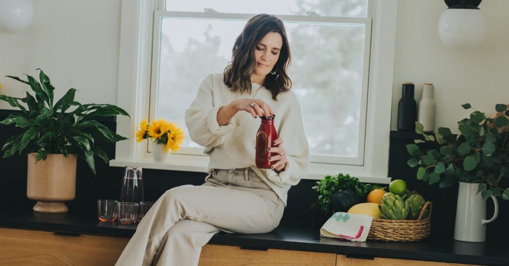 Dr. Maren sitting on a kitchen counter with fresh juice
