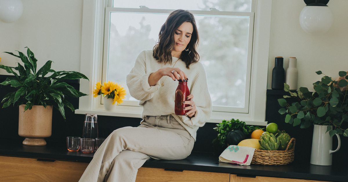 Dr. Maren sitting on a kitchen counter with fresh juice