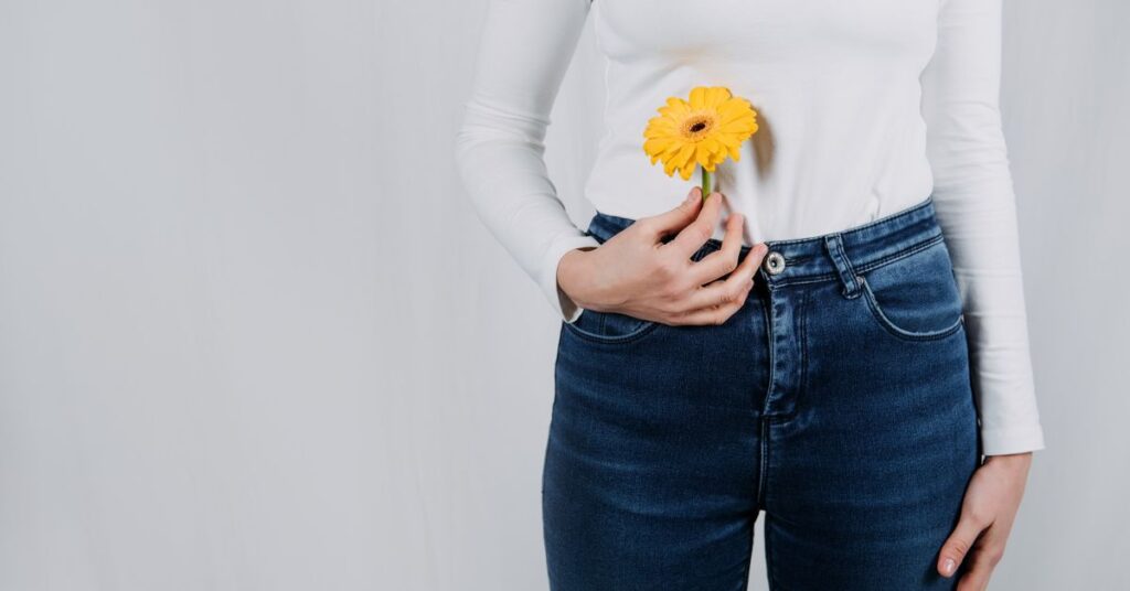 A woman holding a yellow flower