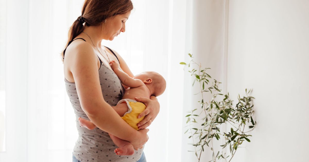 A postpartum woman holding her newborn child