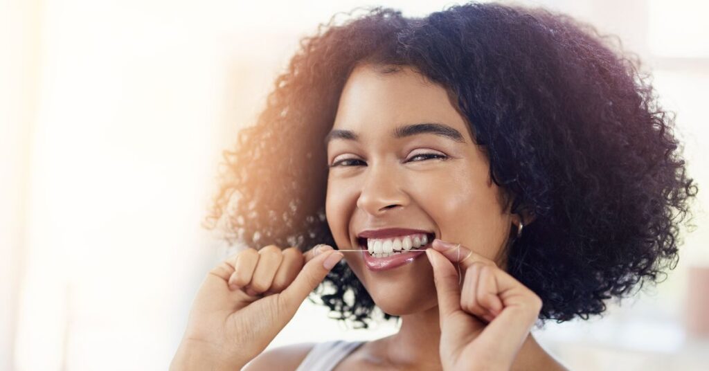 Woman flossing her teeth