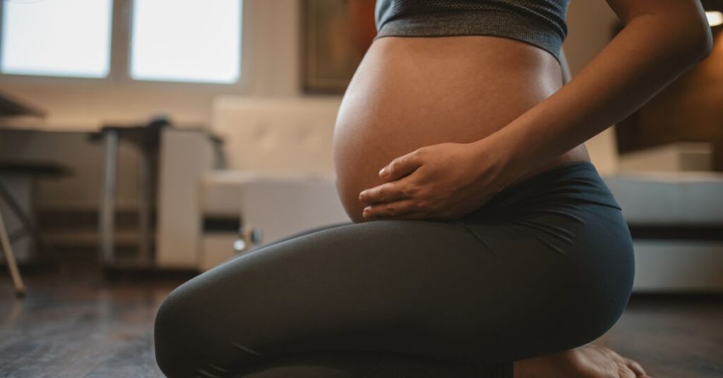 Pregnant woman holding her stomach