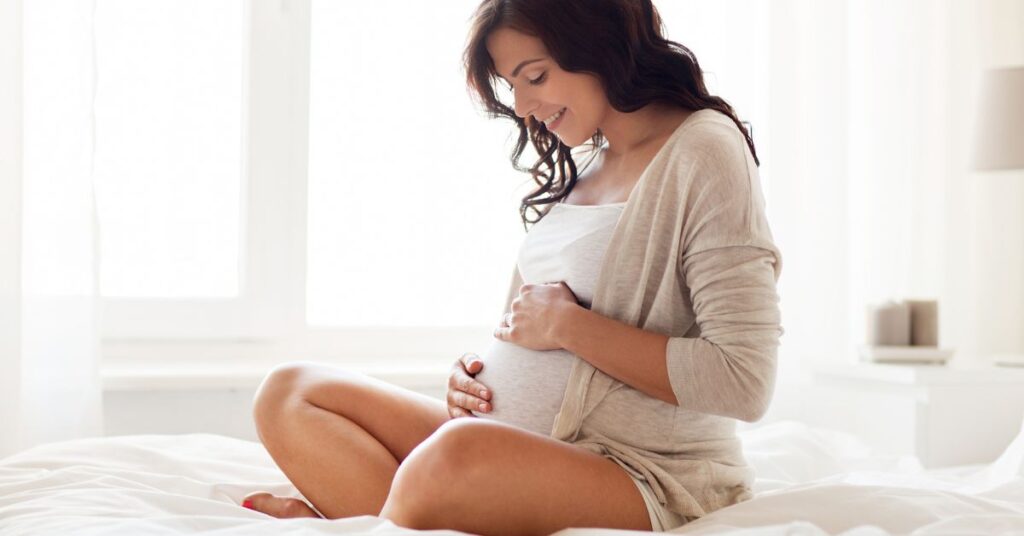 A pregnant woman with her hands on her stomach