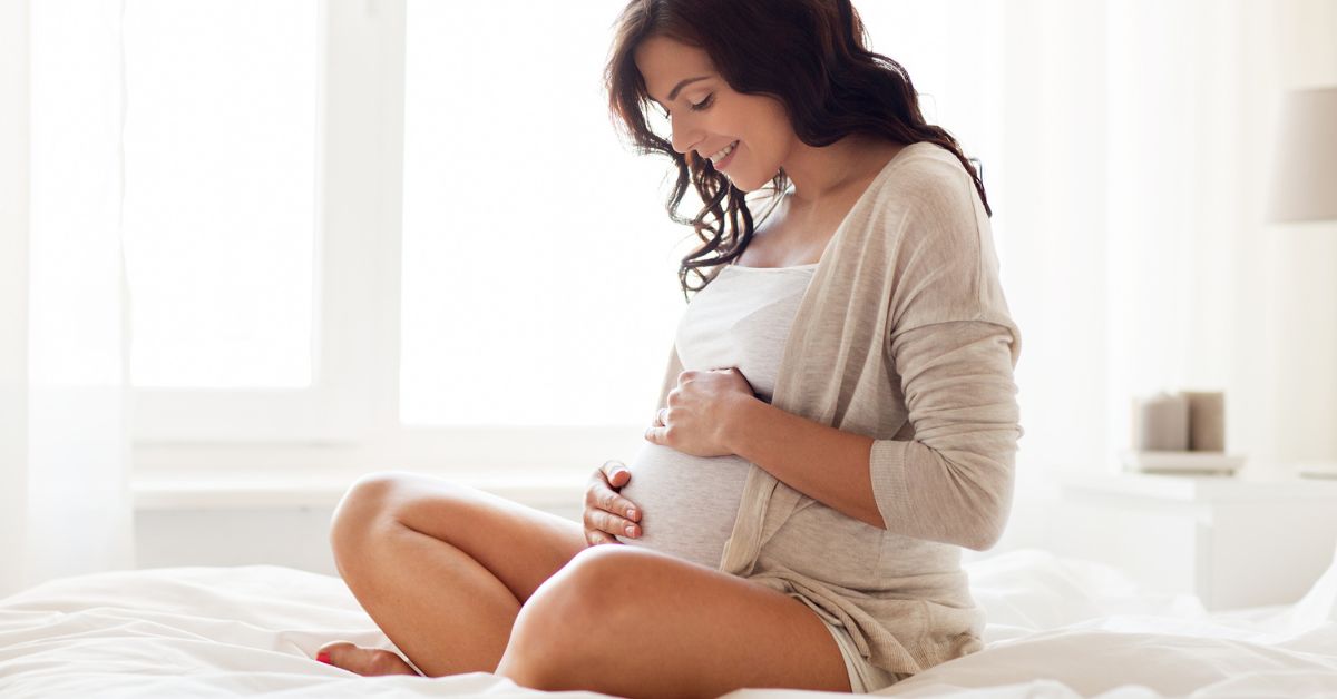A pregnant woman with her hands on her stomach