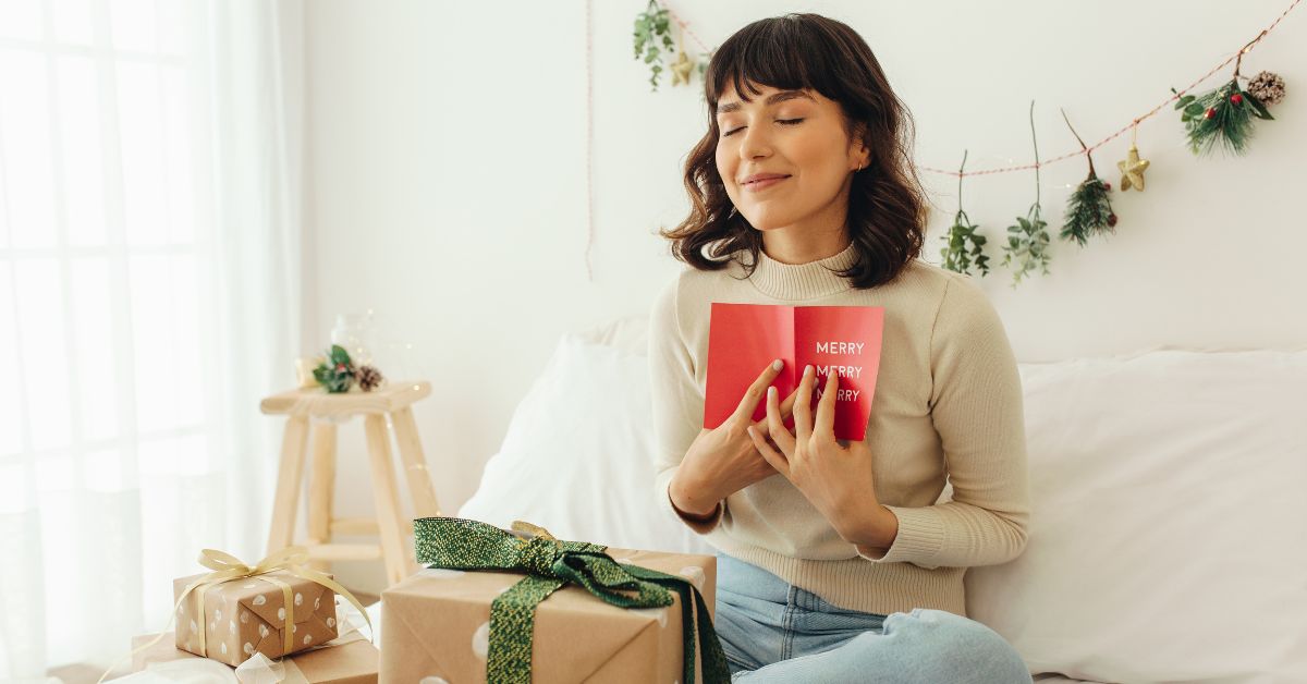 A woman holding a gift to her chest